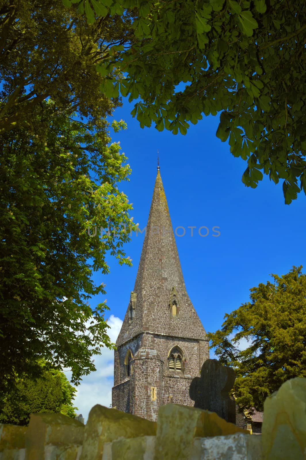 The stone spire of Llanddarog Church, Dyfed, Wales, UK. This imposing Norman church is situated on a hill. Its spire is a landmark for the village and can be seen for miles.