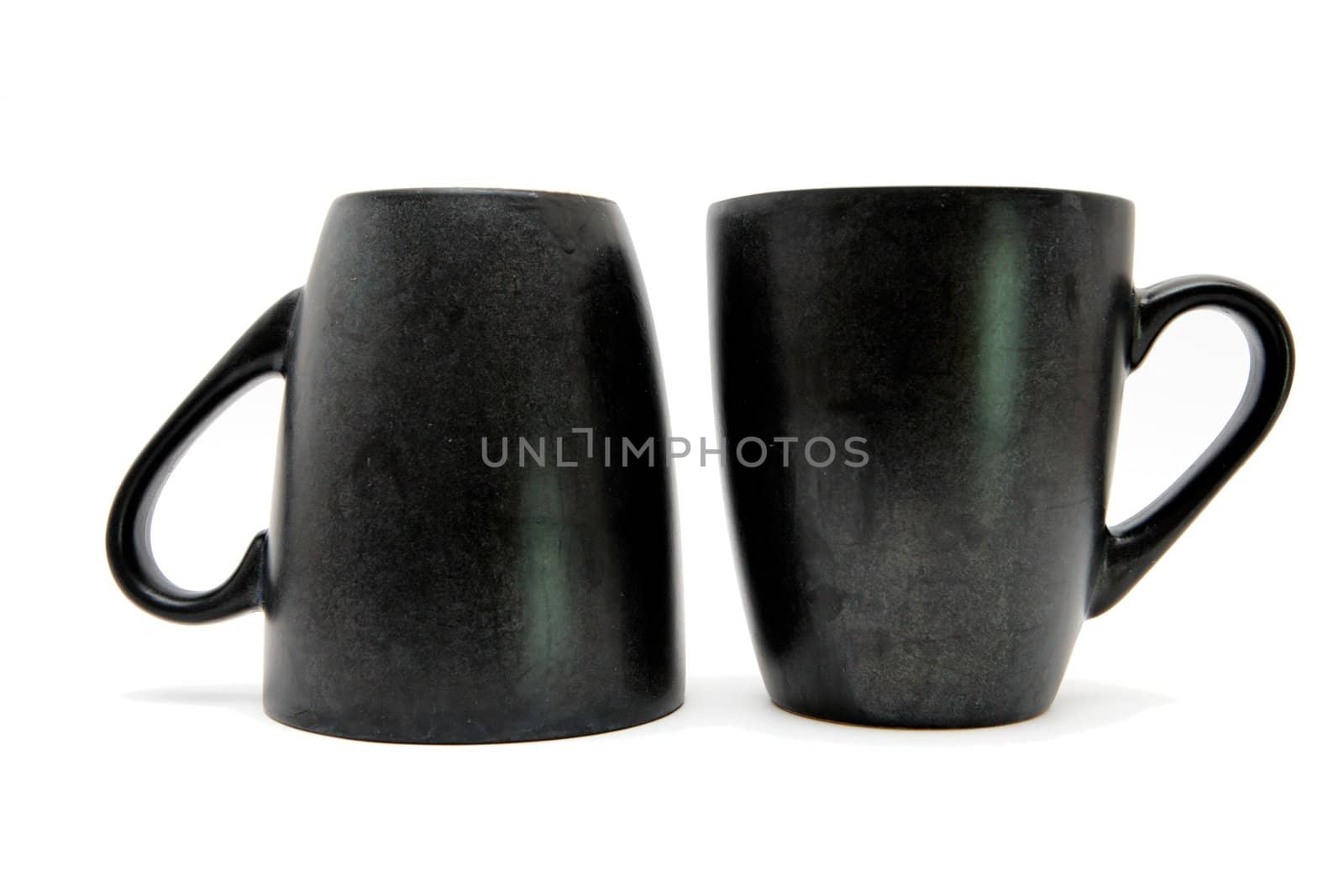 Two black coffe cups up and down isolated