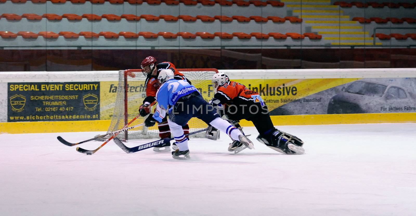 ZELL AM SEE, AUSTRIA - FEB 13: Salzburg hockey League. Goalie Hochwimmer dives to the net to save the puck. Game SV Schuttdorf vs HCS Morzg  (Result 9-3) on February 13, 2011 at the hockey rink of Zell am See