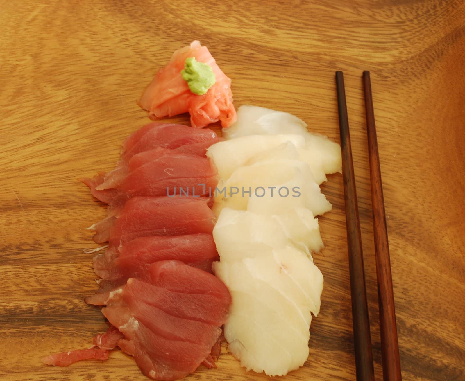 sushi meal with sashimi (tuna and bass) and chopsticks