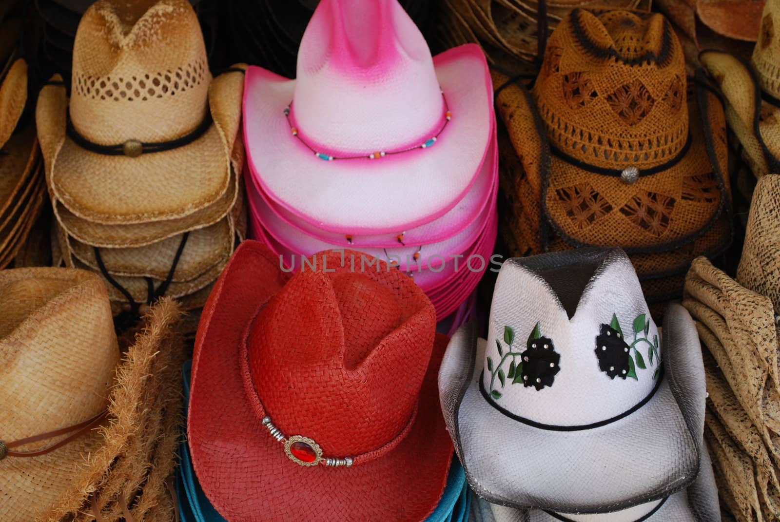 colorfull cowgirl hats stacked for sale at the fair