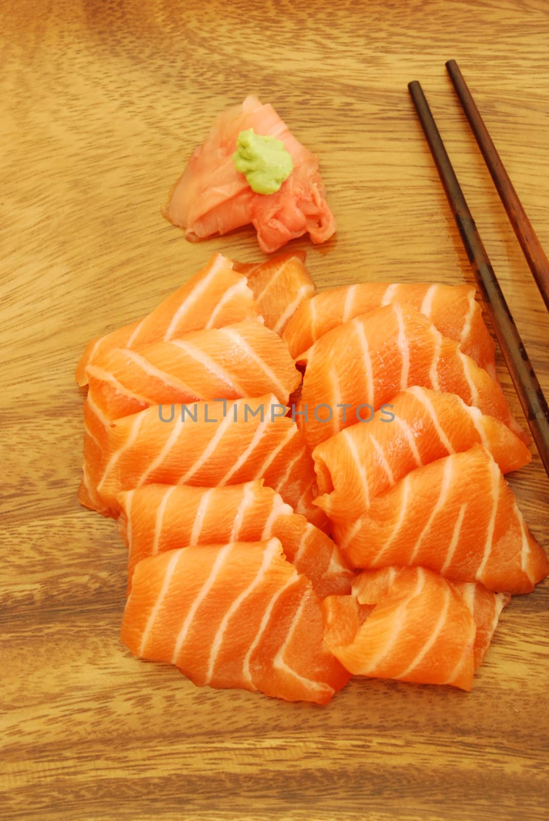 sushi meal with sashimi (salmon) and chopsticks