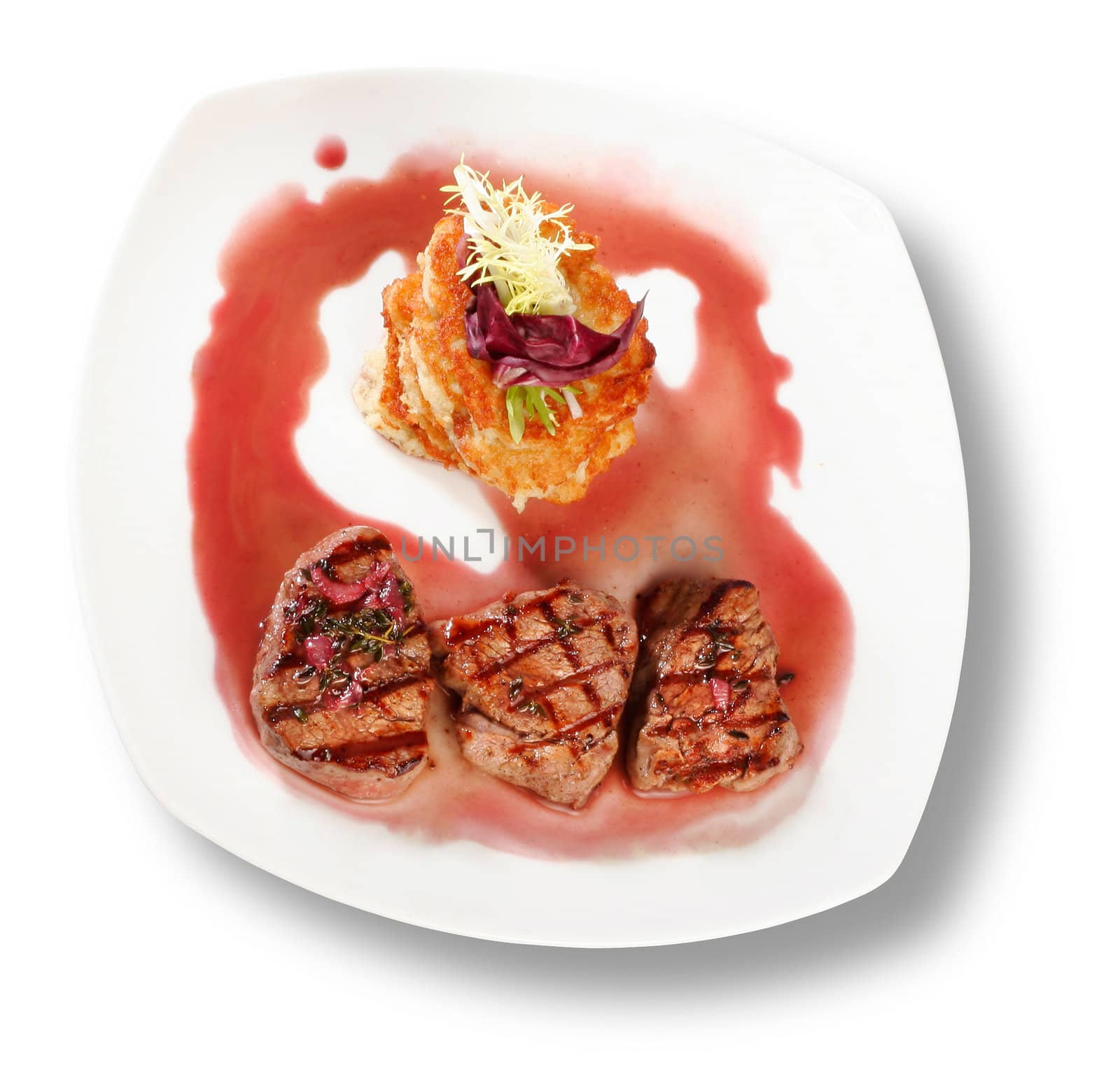 Veal Medallions with potato pancakes. Closeup. File includes clipping path for easy background removing