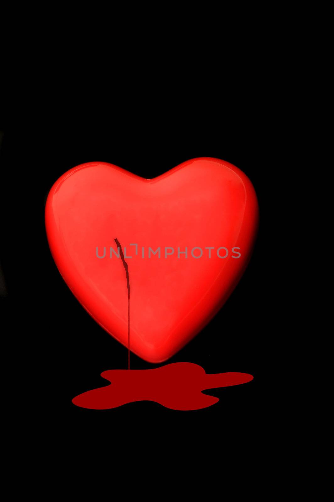Bleeding Red heart isolated on a dark back ground