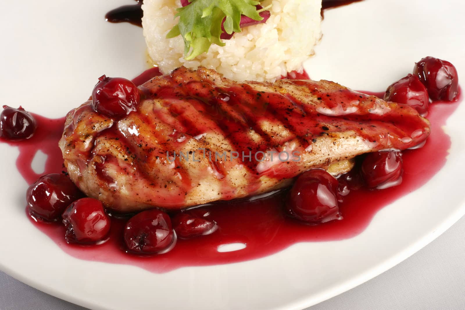 Chicken grill with rice and cherry sauce. Closeup