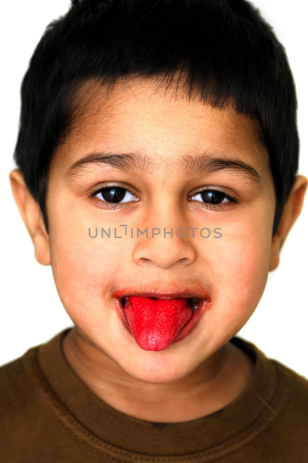 An handsome Kid showing his tongue after eating a candy