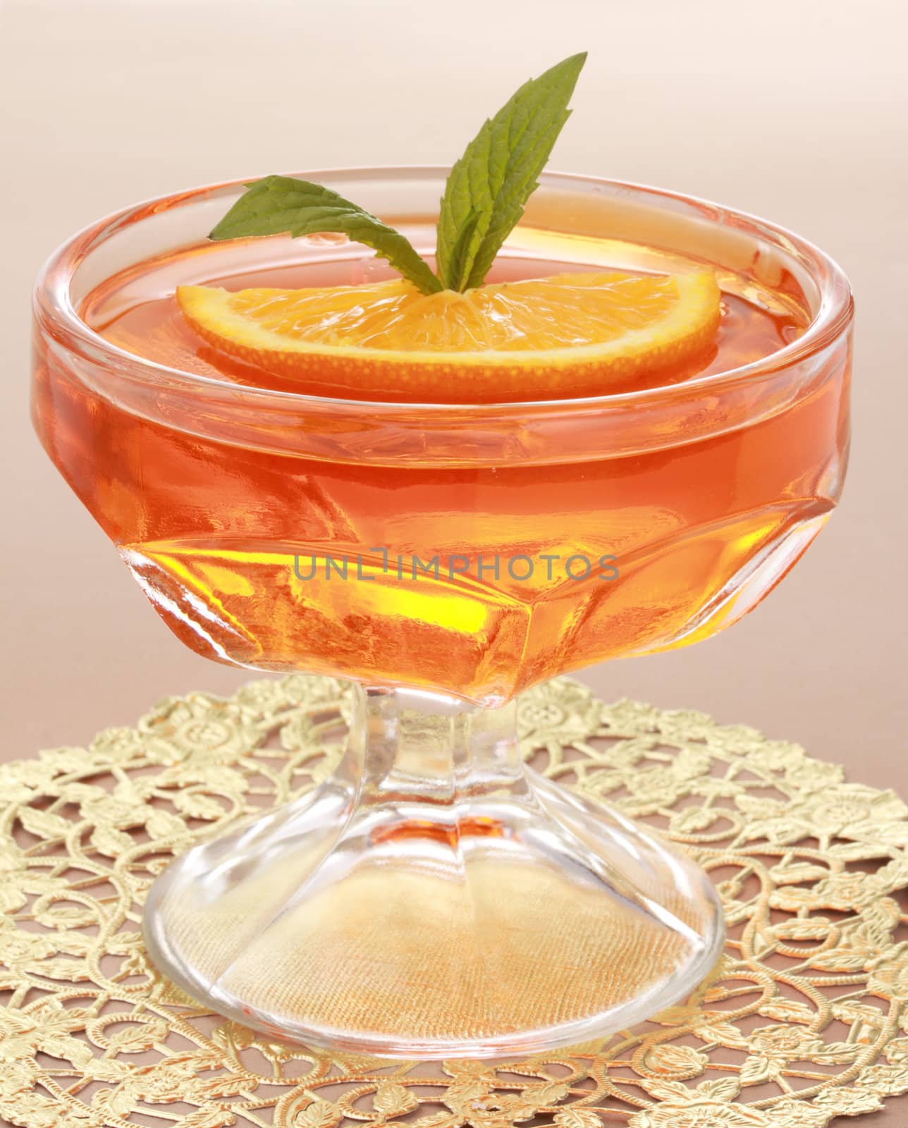 orange jelly dessert with leaves of mint