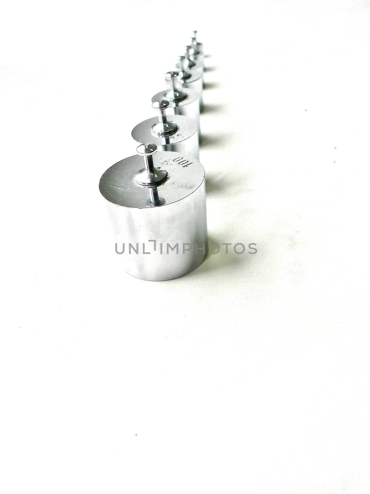 different sizes of small  weights lined up 