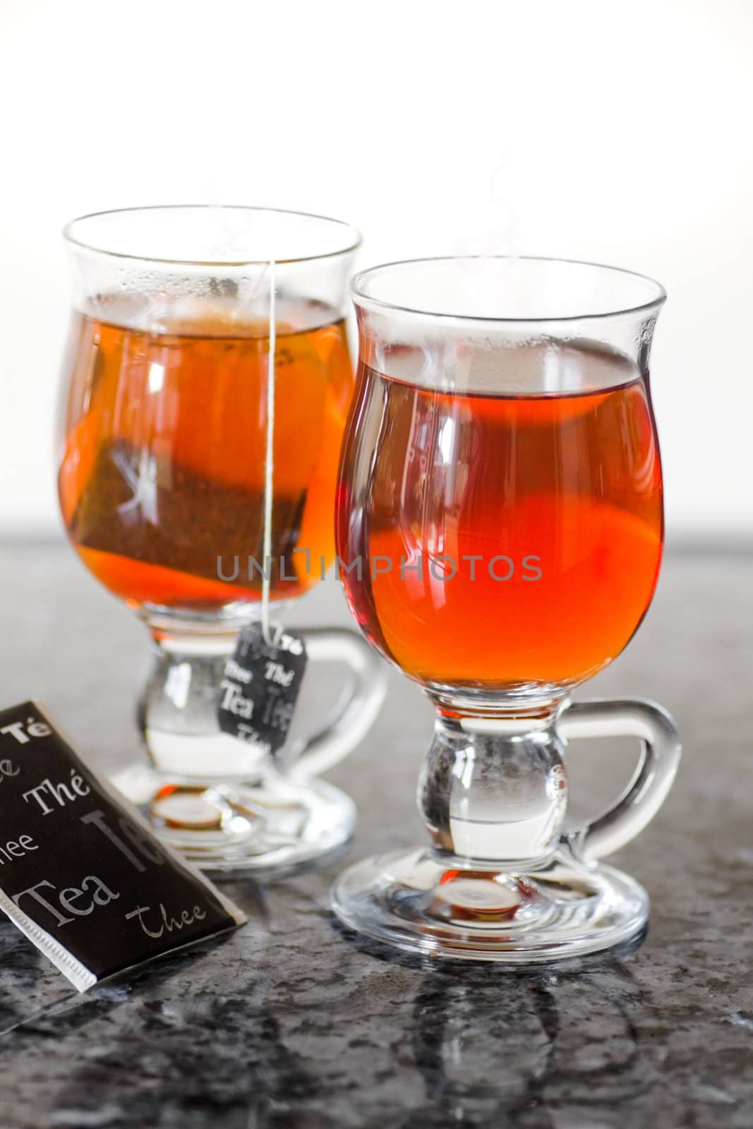 Teaglasses with tea on kitchen dresser by natural light - vertical and shallow dept of field