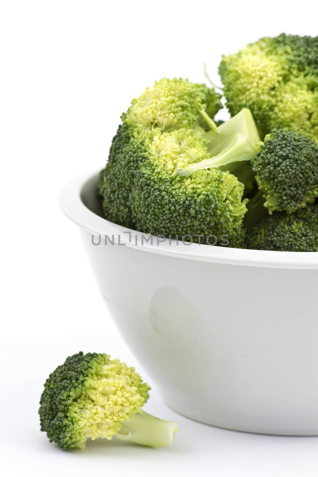 broccoli in a bowl on white background by miradrozdowski