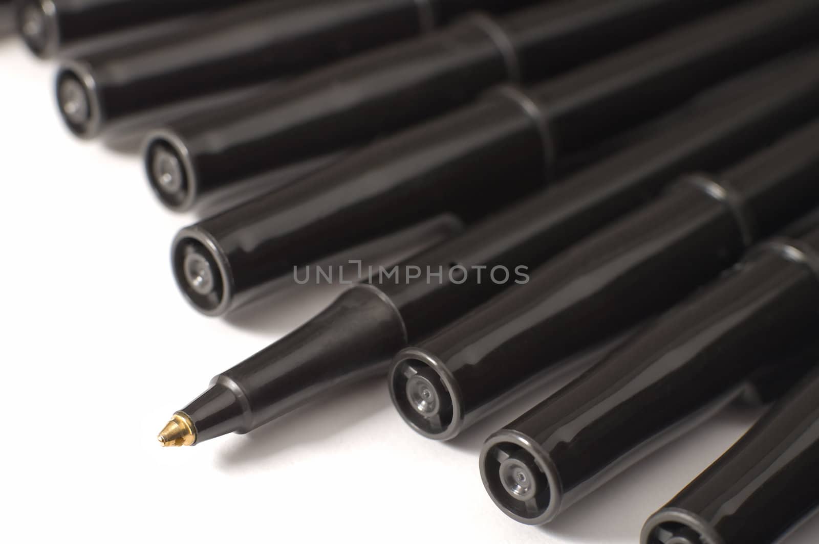 black pens isolated on white background, only one is open, 