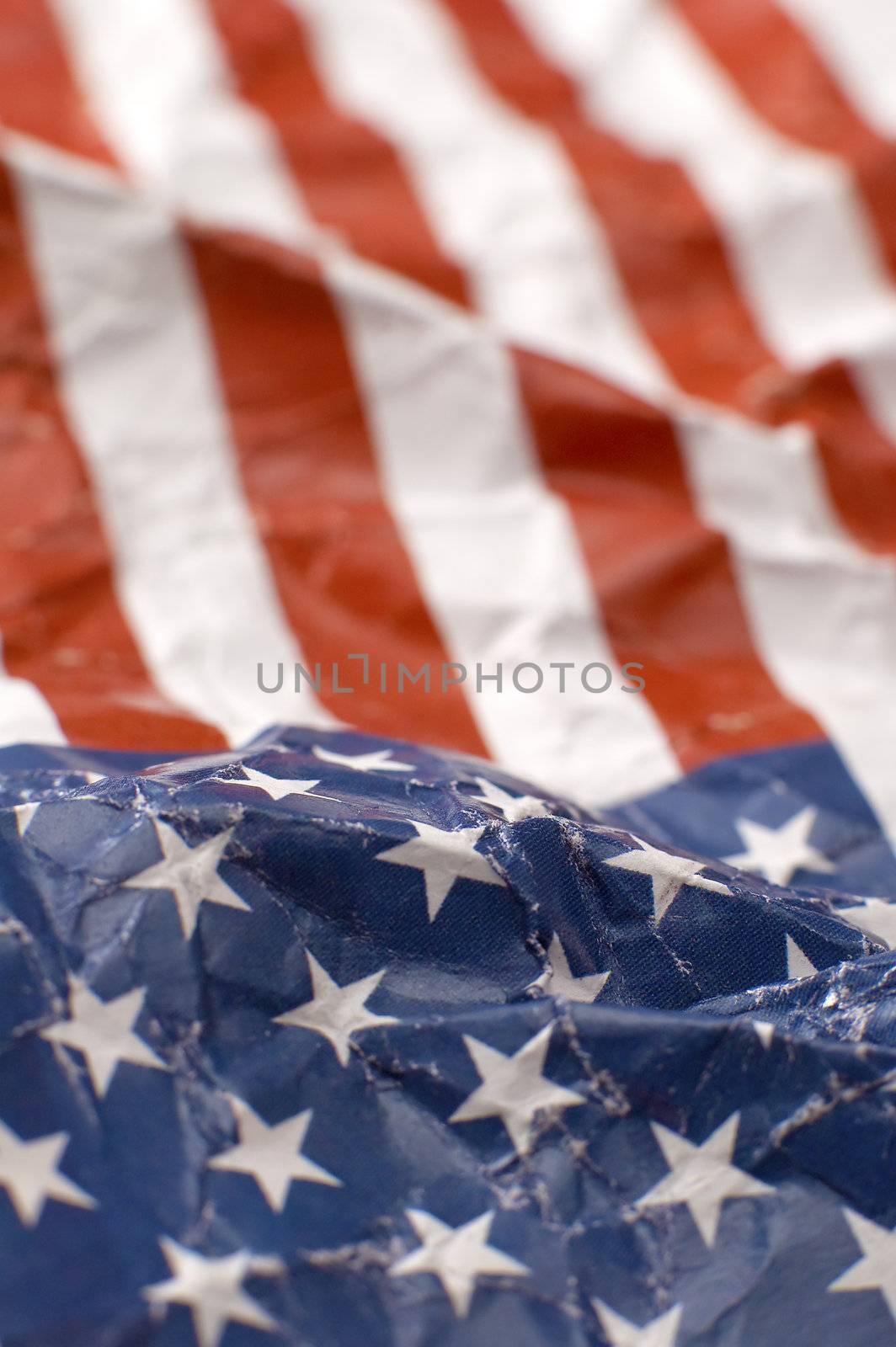 wrinkled paper USA flag, shallow depth of view, vertical photo