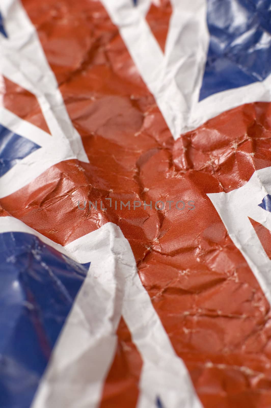 wrinkled paper flag of United Kingdom, shallow depth of view, vertical photo