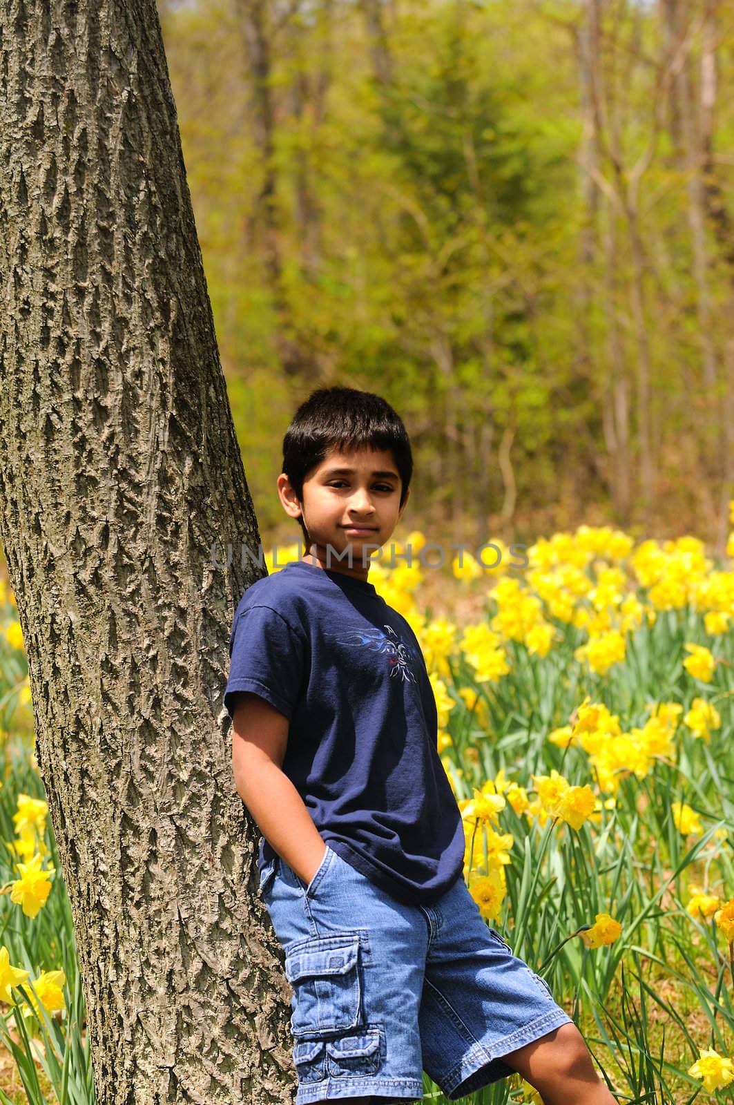 An handsome indian kid model posing at a local park