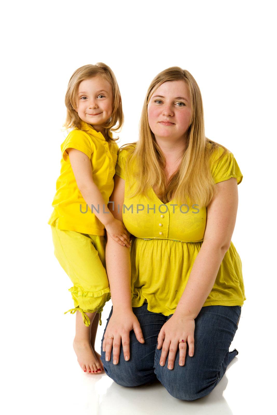 mother and daughter posing together isolated on white