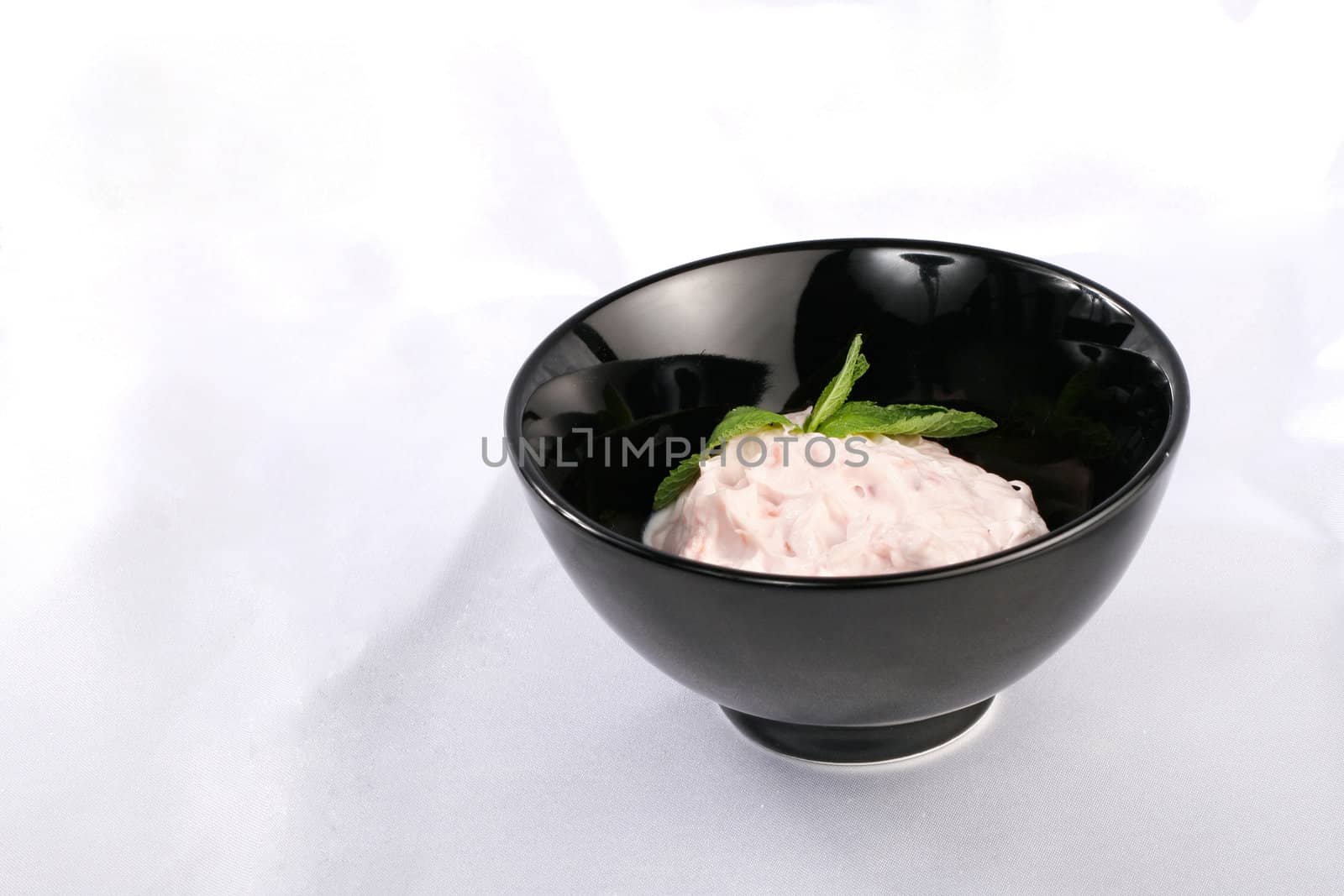 Black plate with cream pink sauce by igor_stramyk
