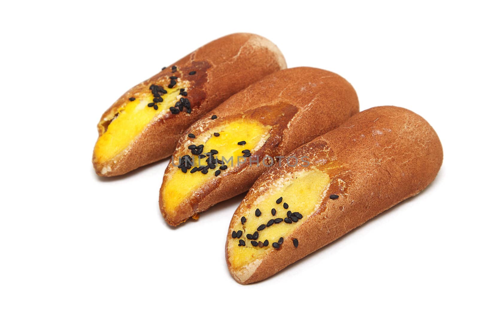 Three Japanese cakes with black sesame seeds isolated over white background