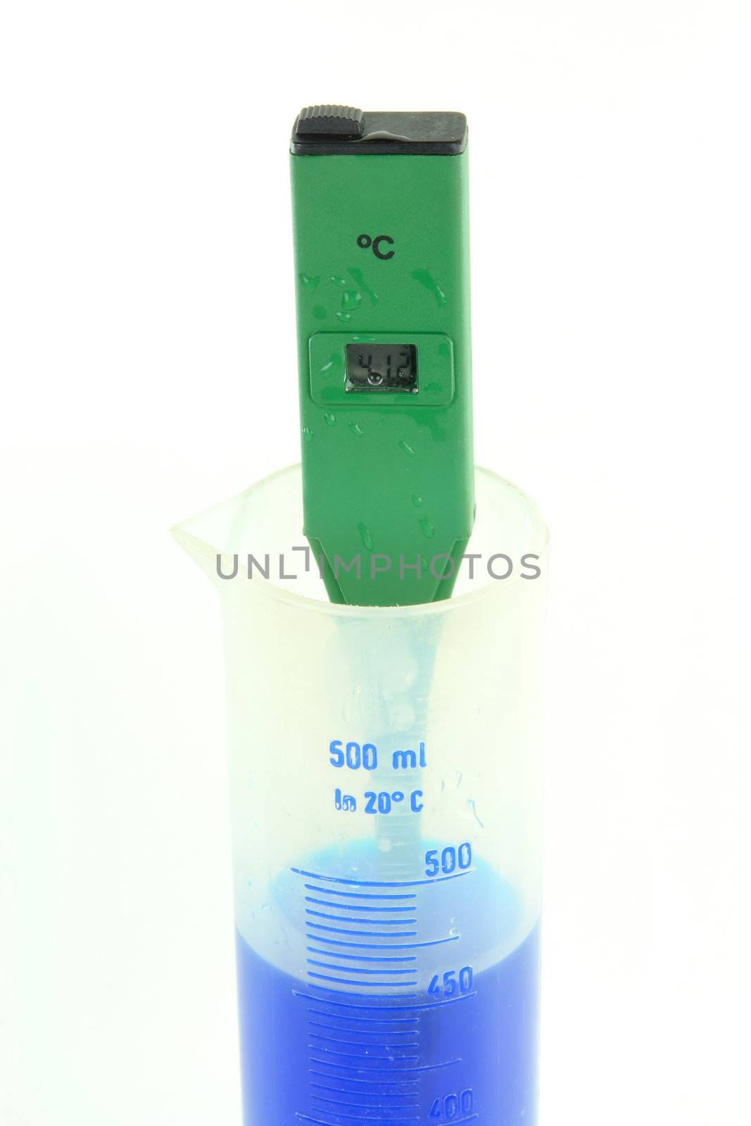 Picture of process of measuring of temperature of blue coloured solution with green waterproof electronic, digital, temperature tester. 