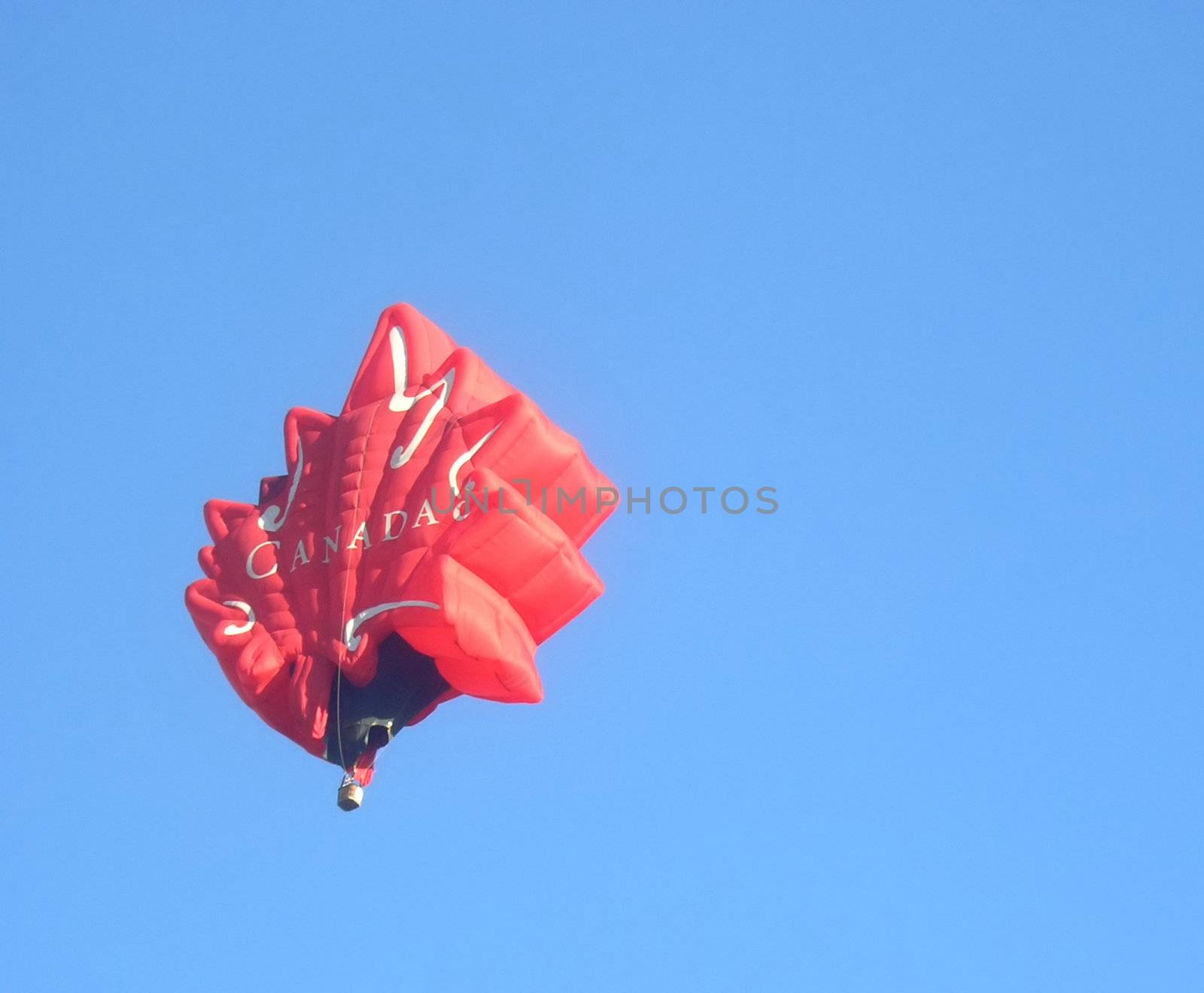 Hot air balloon shaped as maple leaf the symbol of Canada. London Balloon Festival August 2007. 