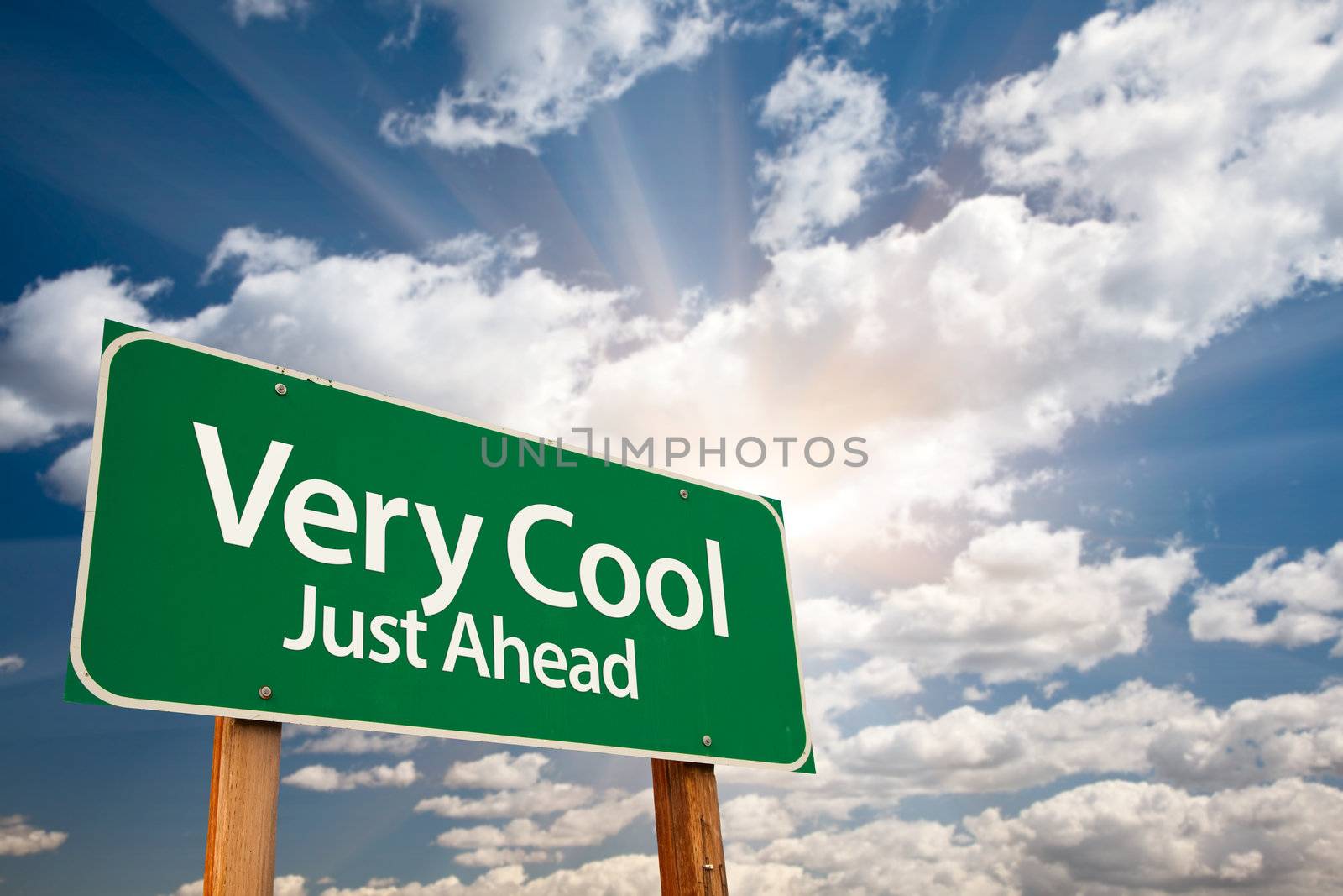 Very Cool Green Road Sign with Dramatic Clouds, Sun Rays and Sky.