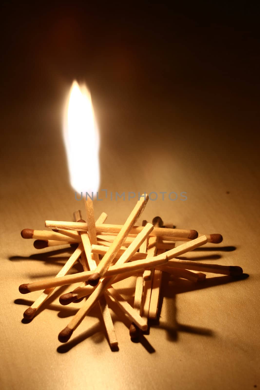 A group of matches with one of them burning