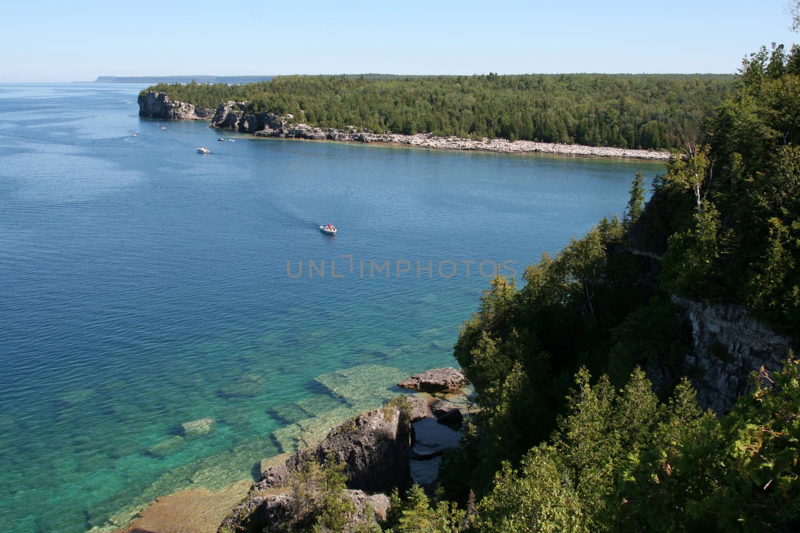 The view from a top the cliffs at Georgian Bay in  Bruce Penisula National Park in Ontario, Canada.  Featuring a bunch of boats.
