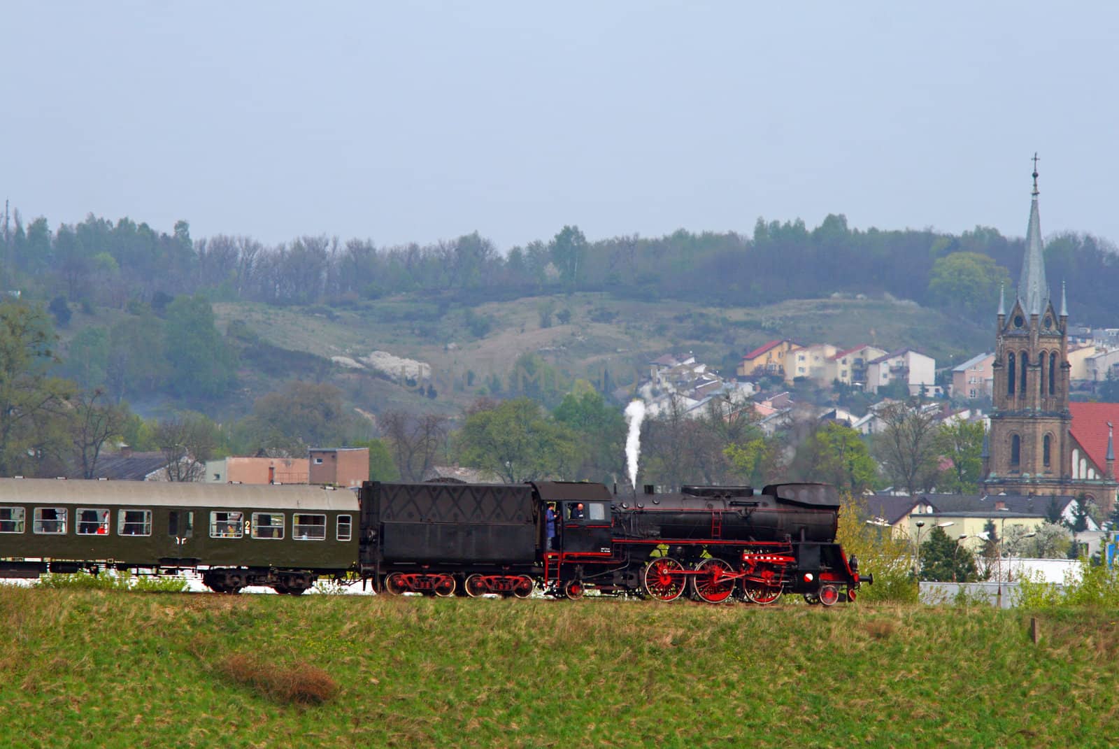 Steam retro train passing the city