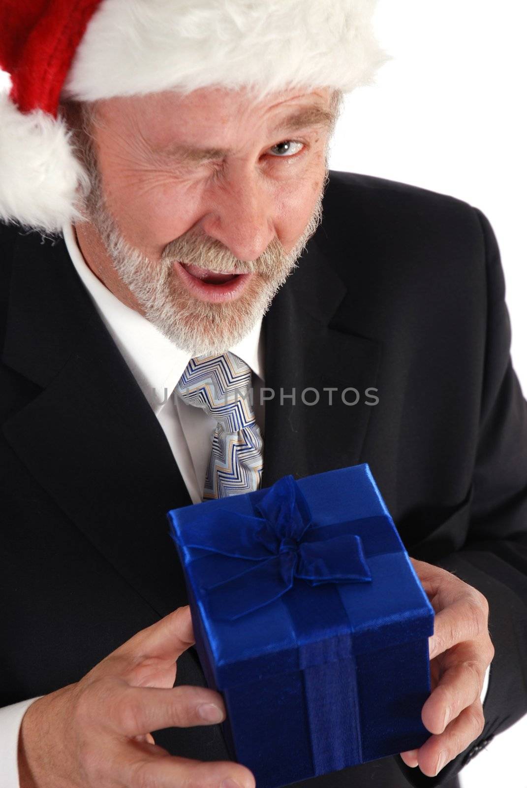 Senior Businessman with Christmas gift and Santa Claus hat.