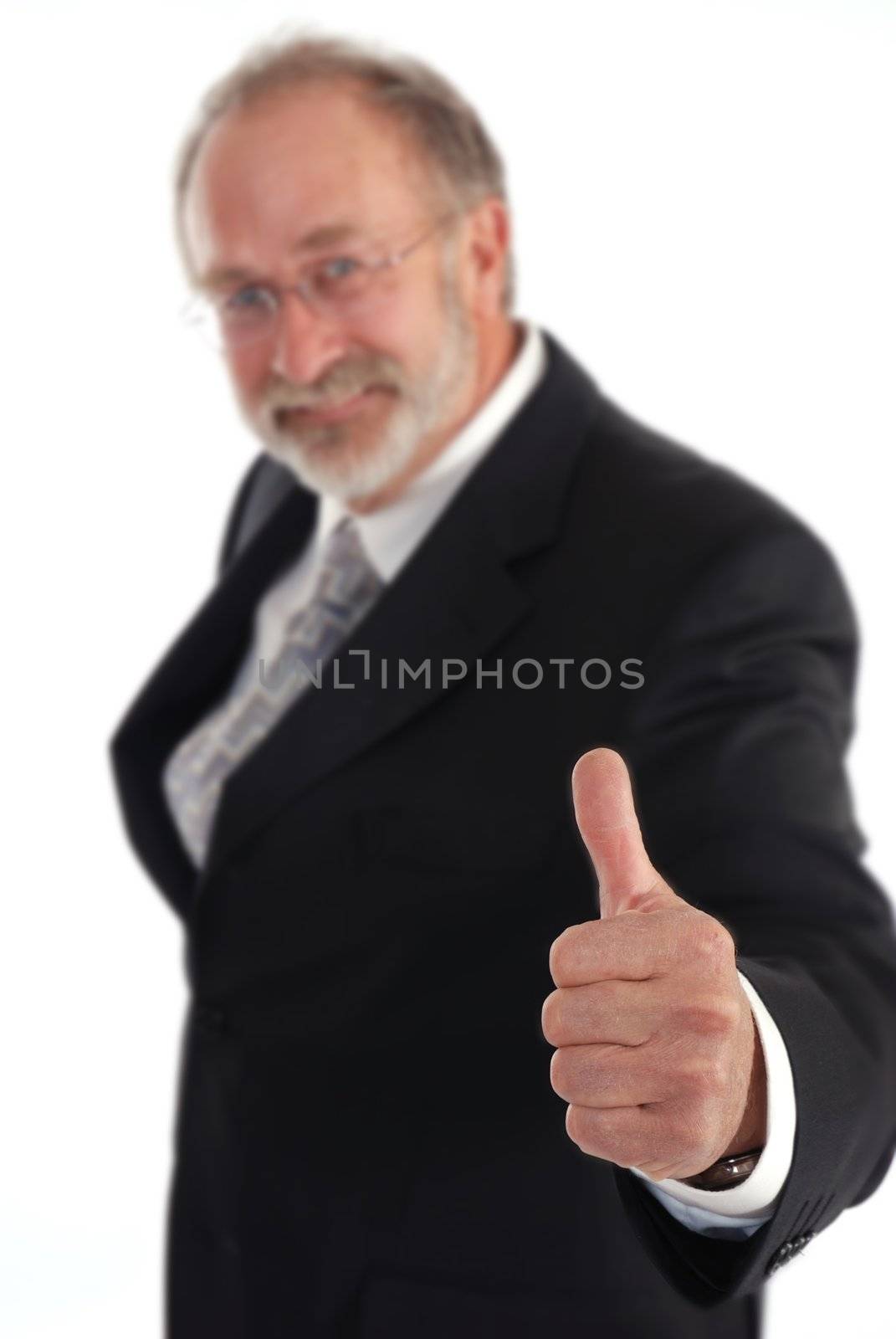 Senior businessman giving the thumbs up. Hand in focus.