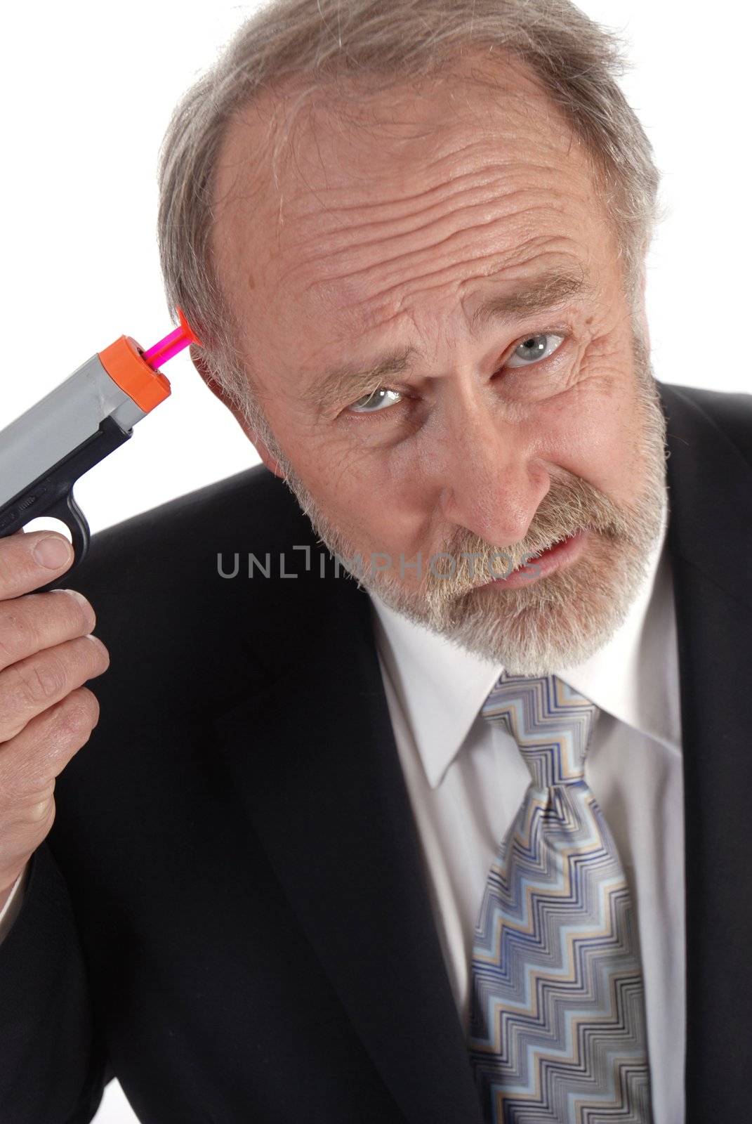 Businessman with a dart gun to his head looking sour. Poor business theme.