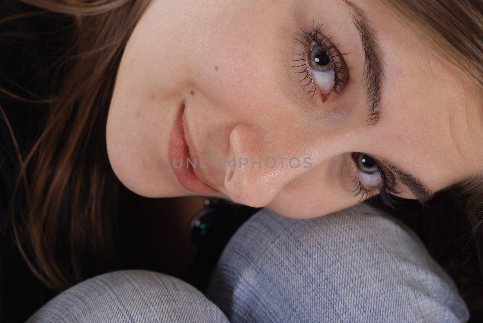 Beauty shot of a brunette curled up to her knees