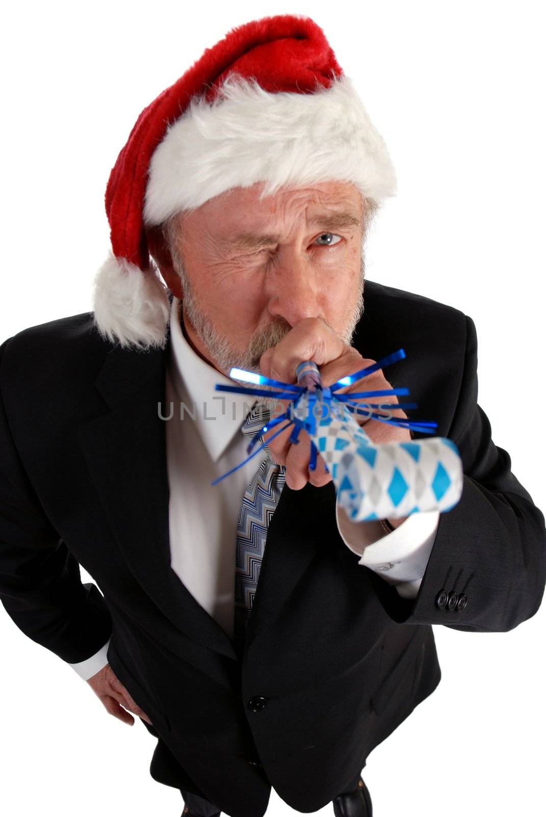 Business man in santa hat blowing party blower