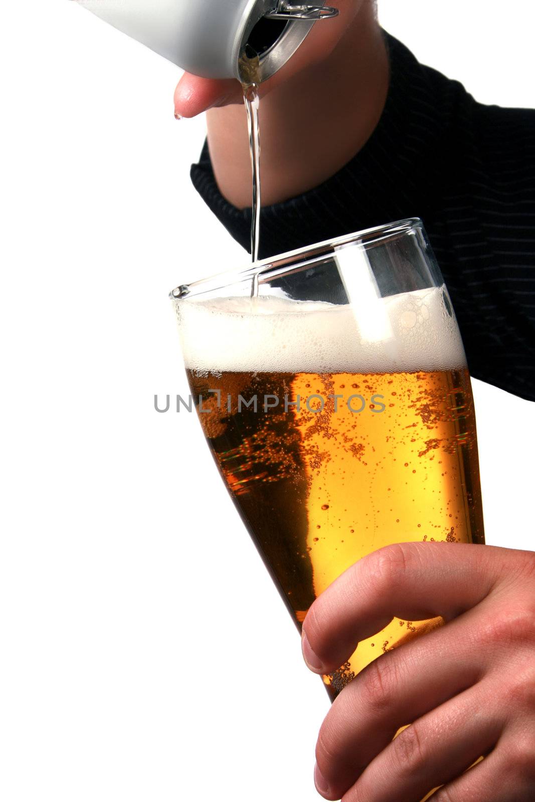 Hands pouring beer into a stein.