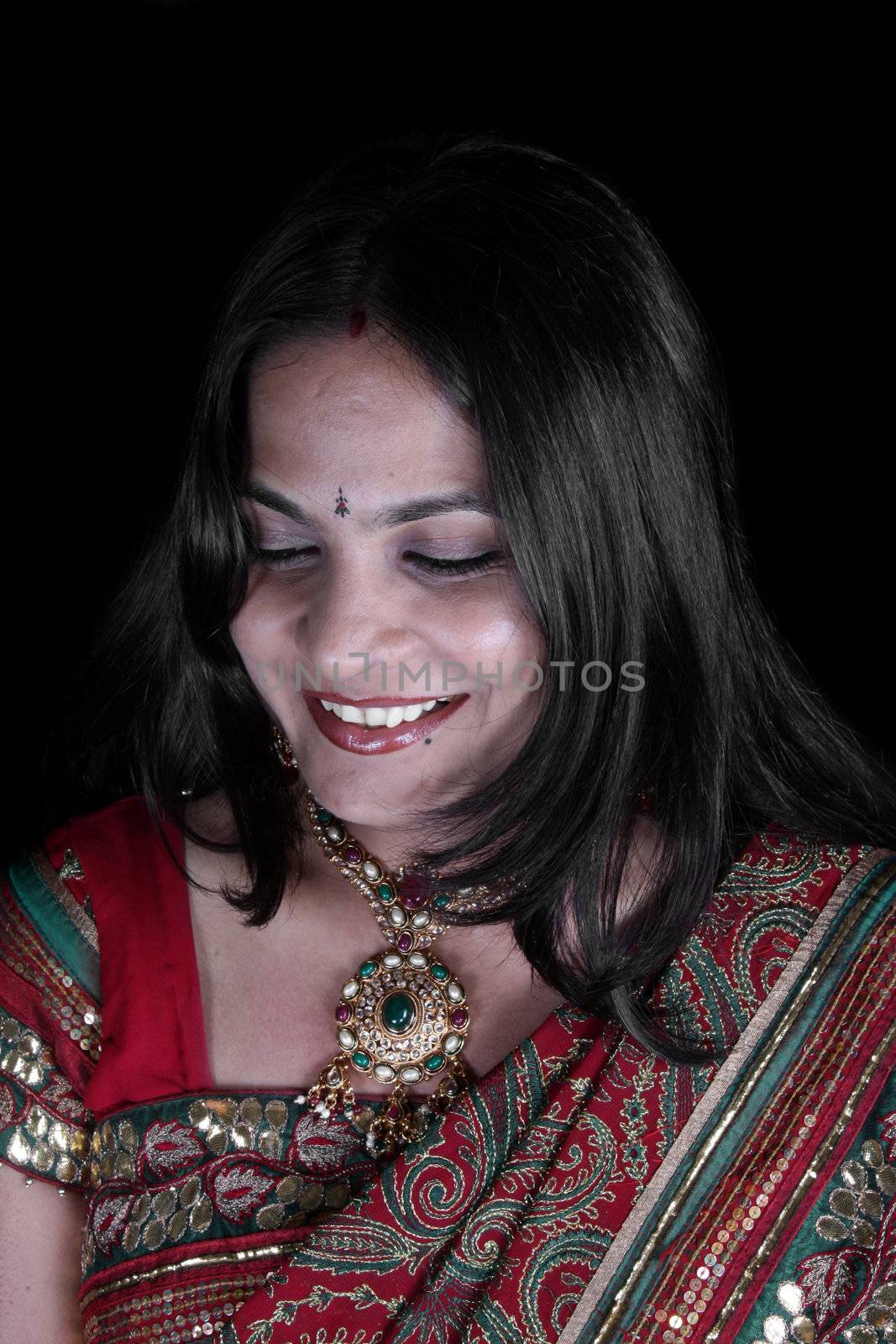 A portrait of a shy embarrassed Indian woman.