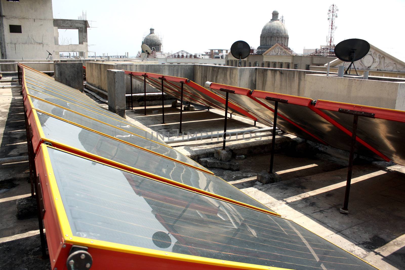 Solar panels set up on the top of the building for using green energy.