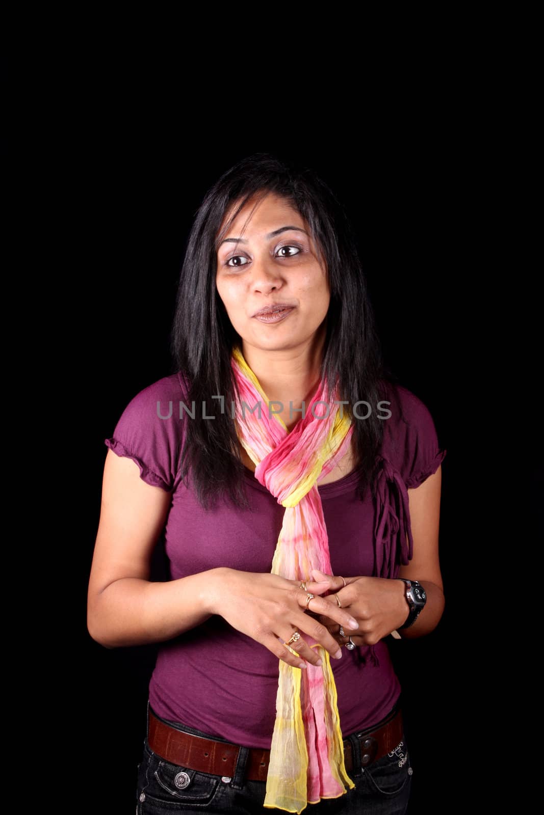 A portrait of a pretty Indian girl, on black studio background.