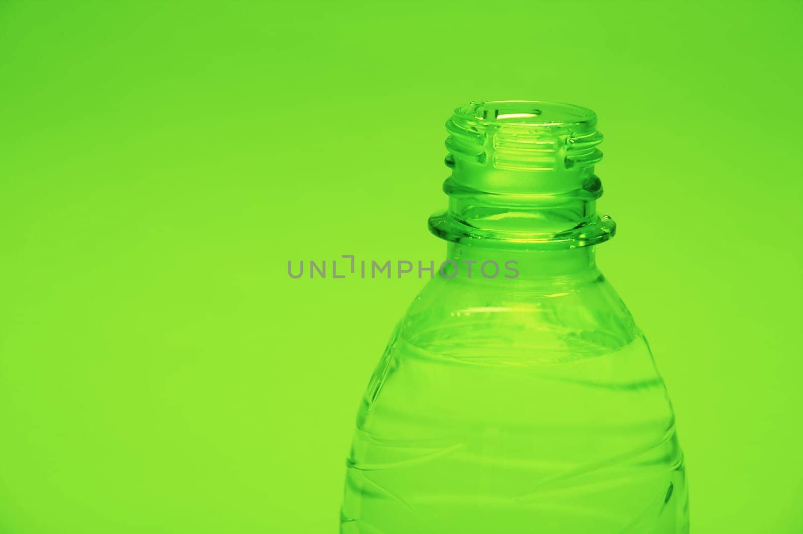 Closeup of a plastic bottle on green background