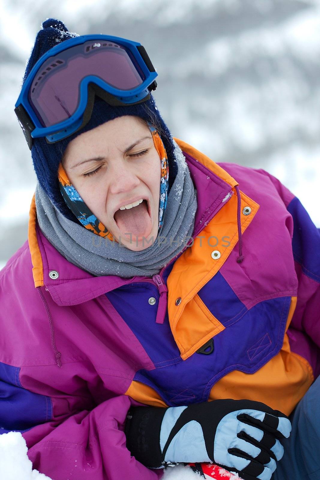 Female skier sticking out tongue