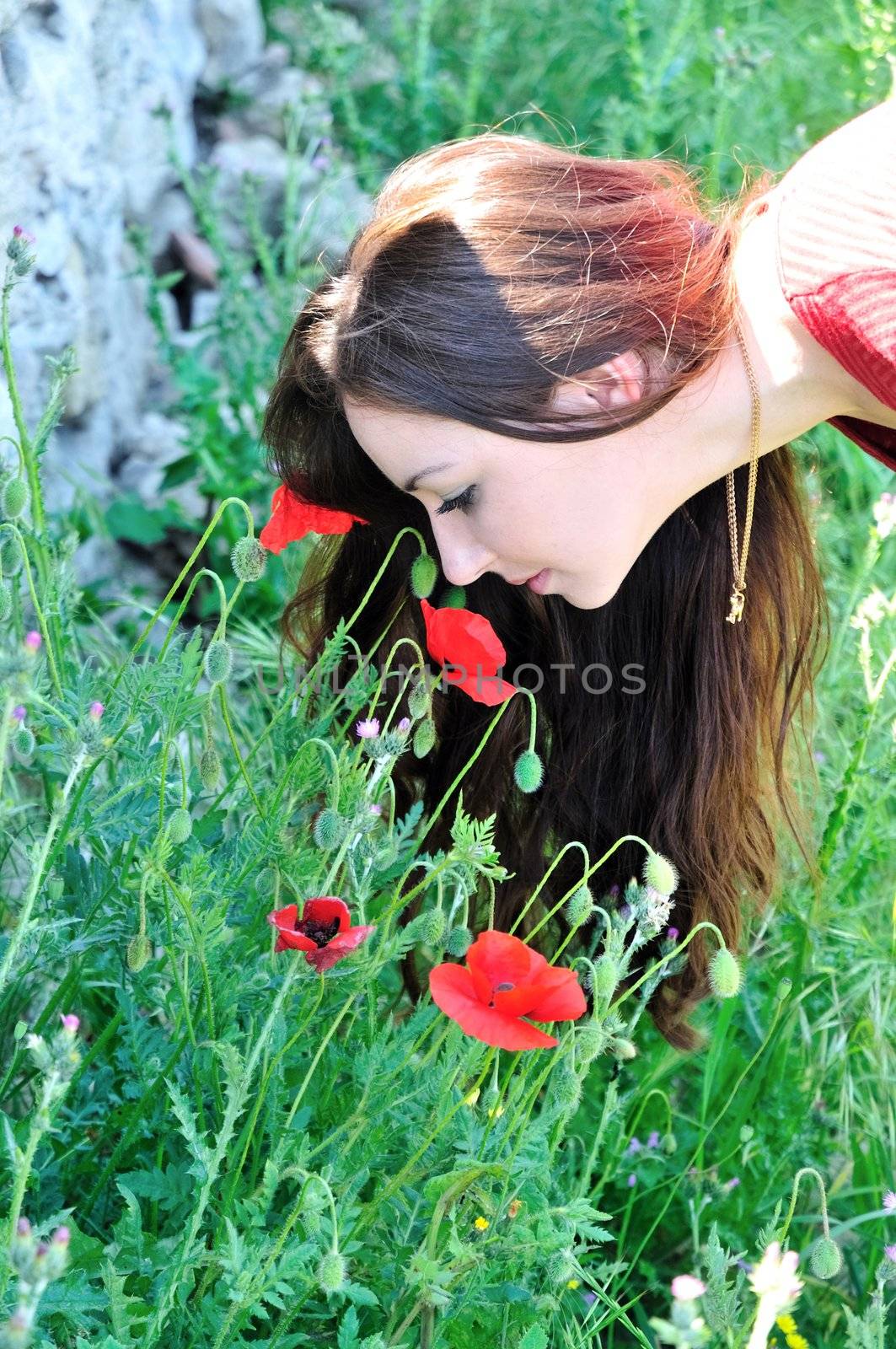 beautiful brunette smelling poppies by Reana