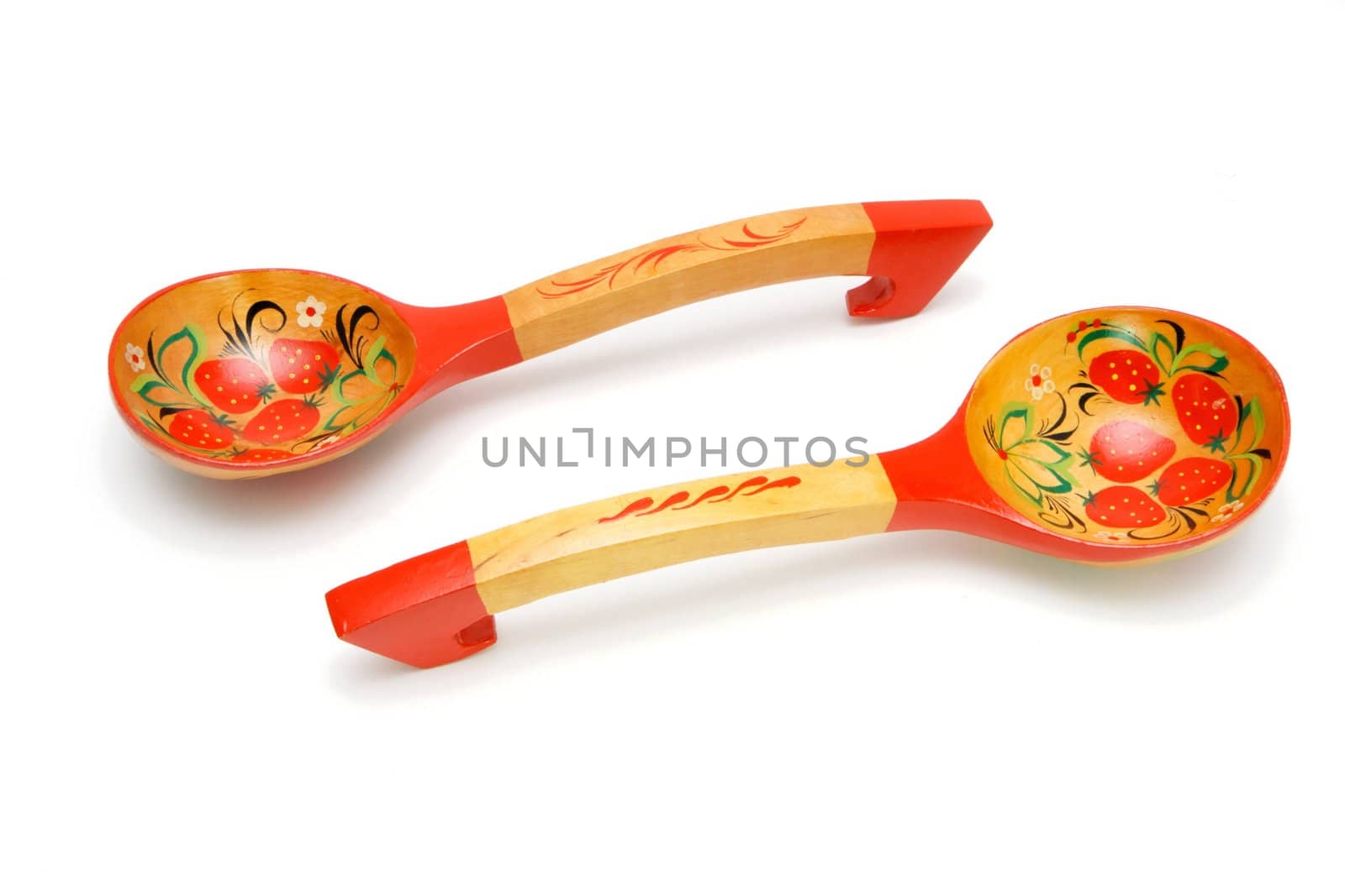 Two wooden Russian hand-painted spoons wih curved handles on white background