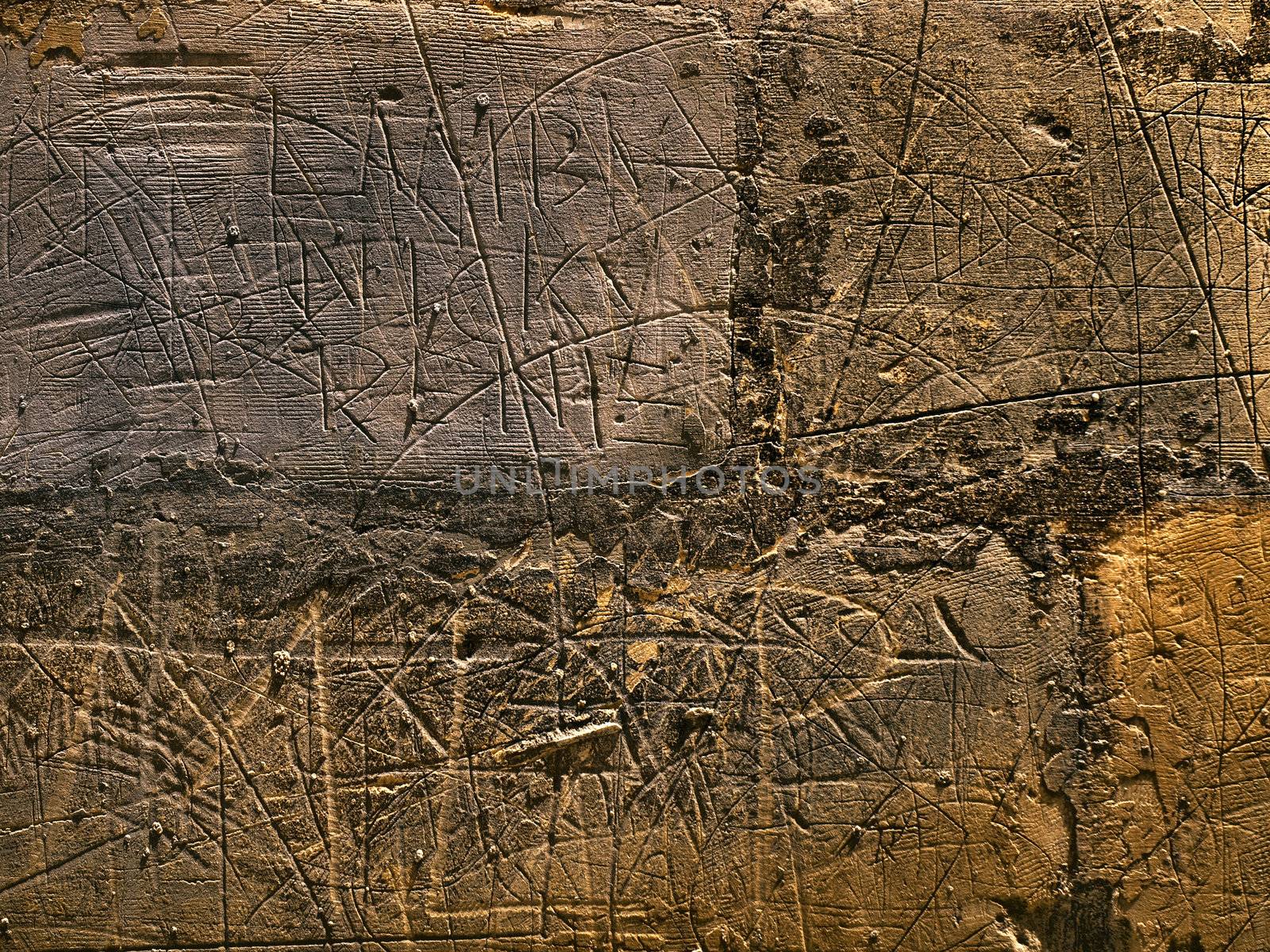 HDR image of scribblings and graffiti on a limestone wall