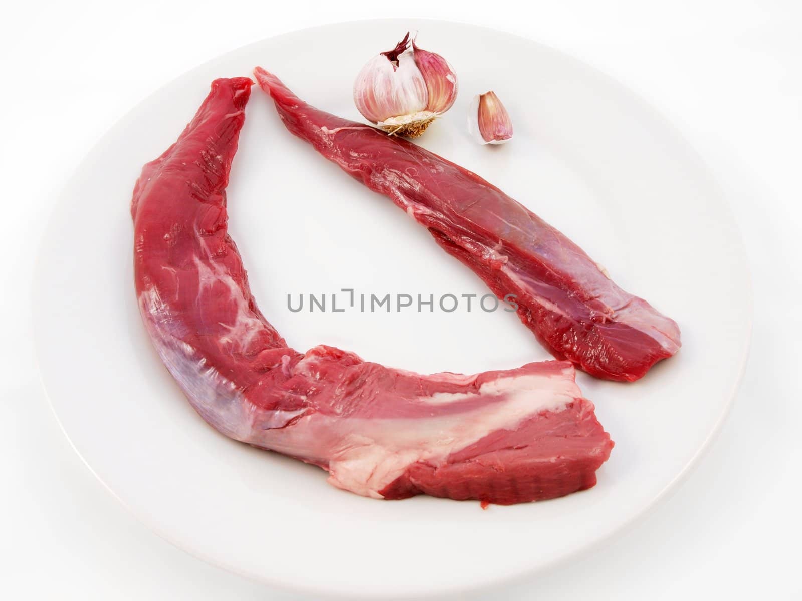 Raw red meat towards white background