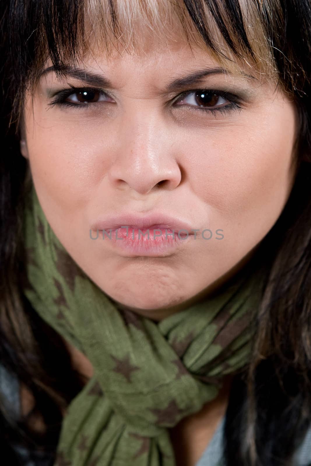 A young woman making a funny face with her lips puckered.