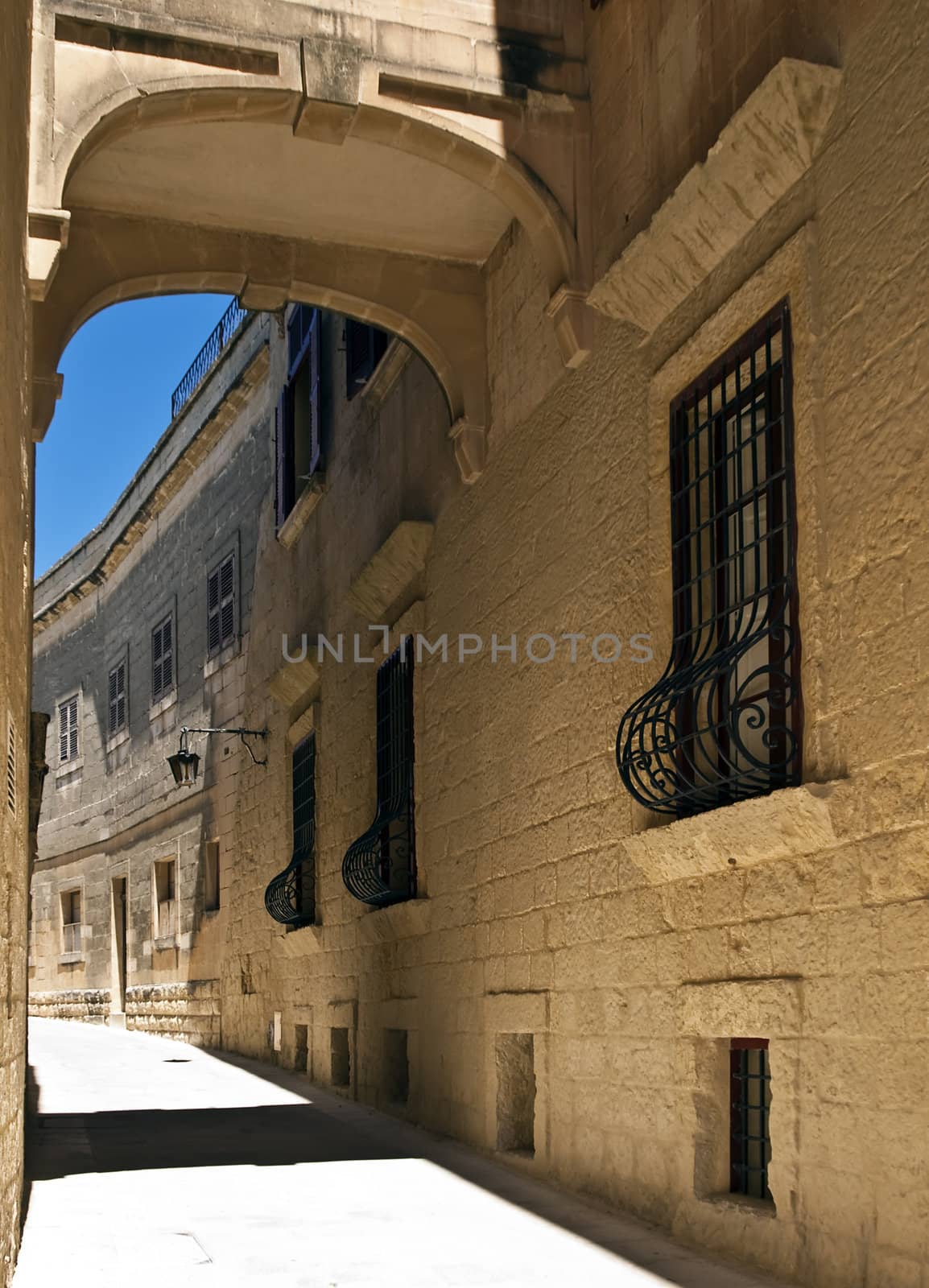 Medieval bridge interconnecting houses in the city of Mdina in Malta