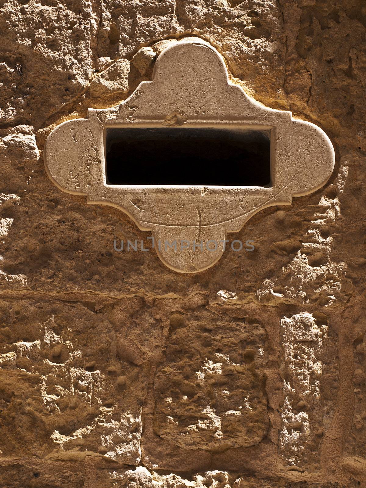 Detail of a limestone letterbox in the old city of Mdina in Malta
