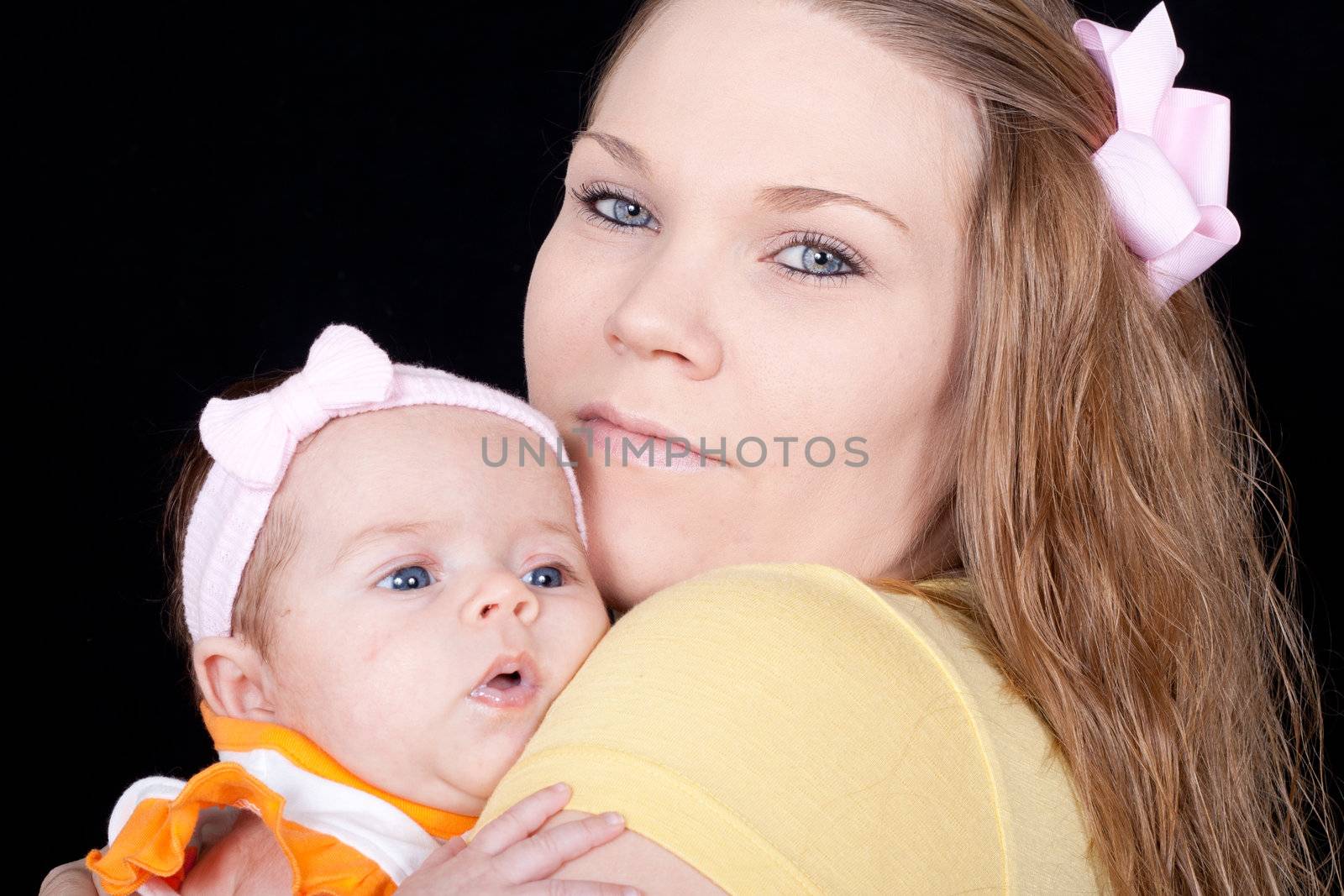 A closeup of a happy mom holding her precious baby.