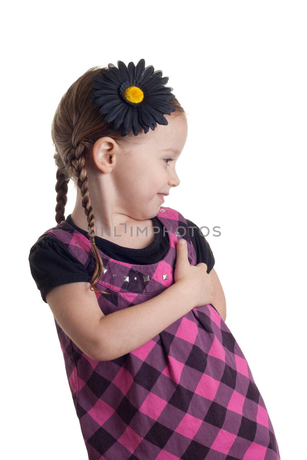 An adorable young girl turning to see what is behind her.