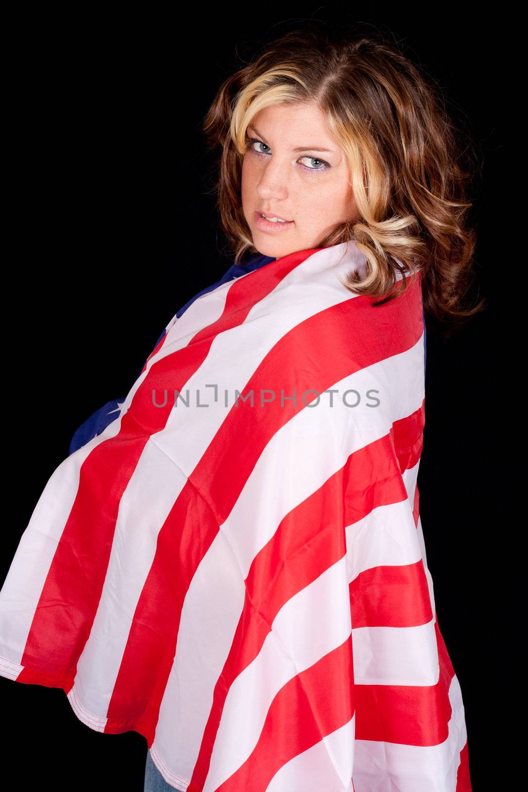 An American girl wrapped with an american flag.