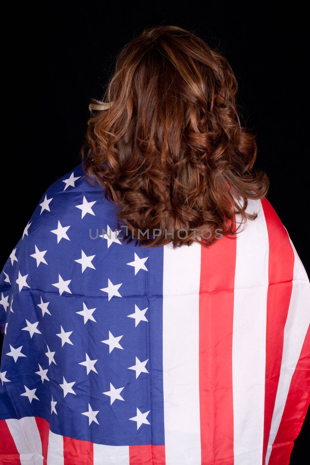 A picture of an American flag hanging from a woman.