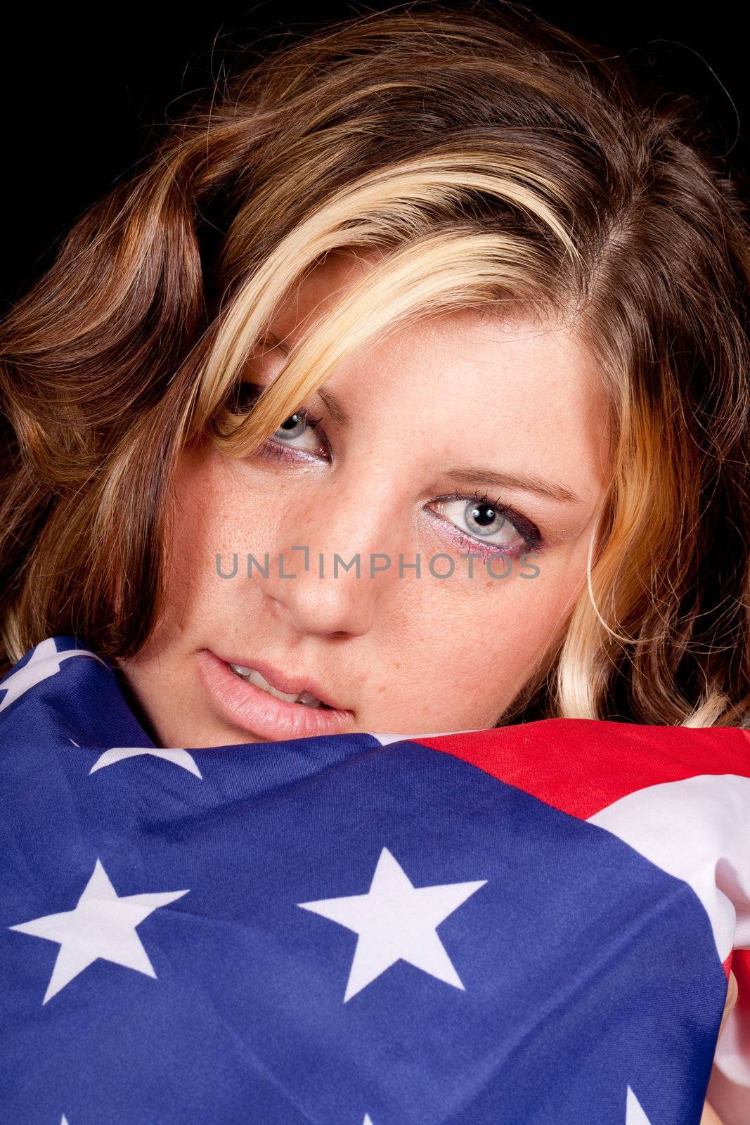 A girl holding the American flag near and dear to her.